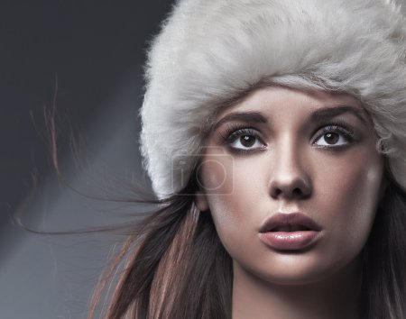 Portrait of a young beauty wearing winter hat