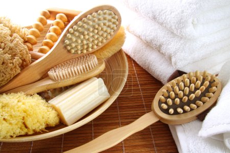 Assortment of spa brushes and accessories on bamboo mat