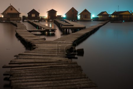 Magnificent long exposure lake at night with fishing houses