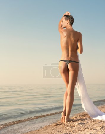 sexy girl posing at the beach