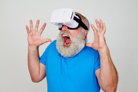 Man in virtual reality glasses scared of 3D picture he sees
