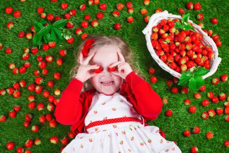 Little girl eating strawberry