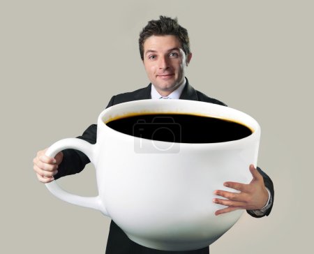 happy businessman holding funny huge  oversized cup of black cof