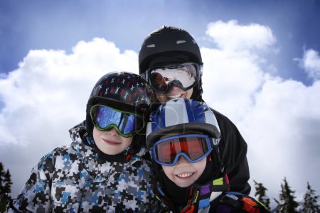 Mother with two boys skiing