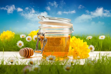 Jar of honey and spring flowers