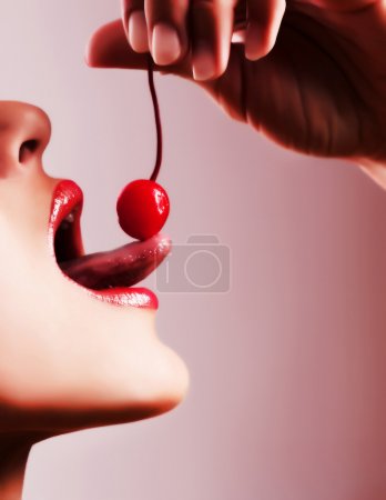 Woman tasting a cherry