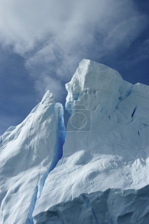 Tip of an iceberg against a blue sky Antarctic summer.