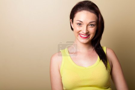 Beautiful young woman studio portrait on simple background