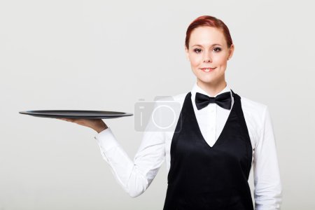 Pretty waitress with an empty tray