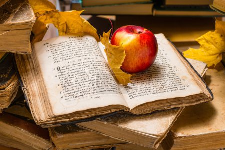 Apple and open old book