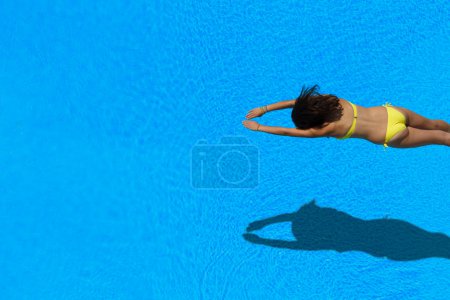 girl diving in the swimming pool