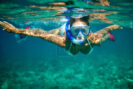 Woman at snorkeling in the tropical water