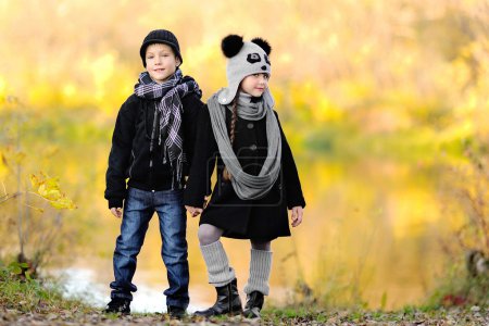 Portrait of little boy and girl outdoors in autumn