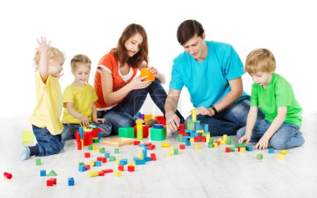 Happy family. Parents with three kids playing toys blocks