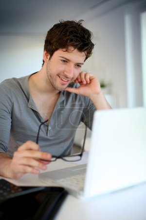 Young man studying from home