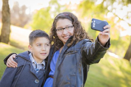 Brother and Sister Taking Cell Phone Picture of Themselves