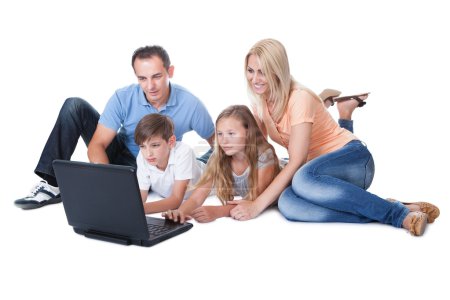 Happy Family With Two Children Using Laptop