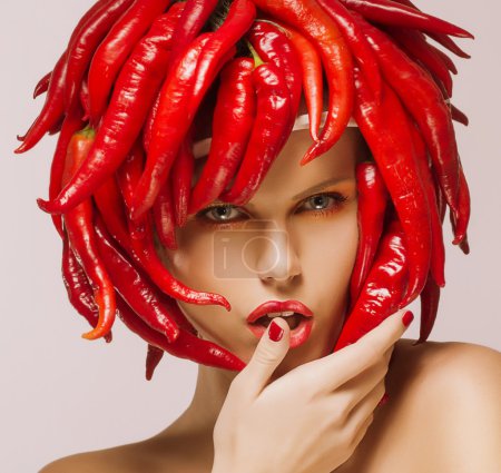 Glamour. Hot Chili Pepper on Shiny Woman's Face. Creative Concept