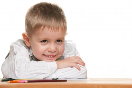 Smiling little boy at the desk