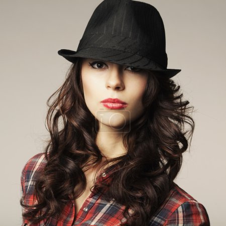 Beautiful brunette girl with classic hat