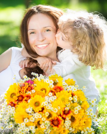 Child and woman with bouquet of flowers