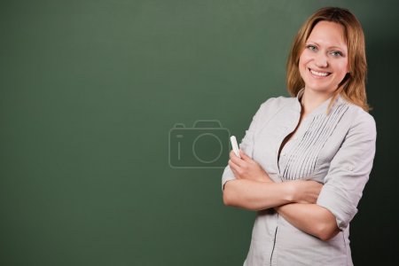 Smiling student or teacher at the blackboard