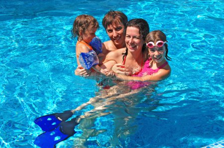 Happy active family with kids in swimming pool