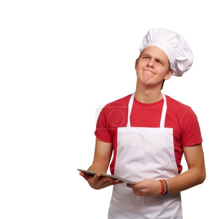Portrait of young cook man holding a digital tablet and thinking