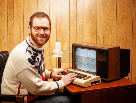 Handsome Nerdy Adult using a Vintage Computer TV