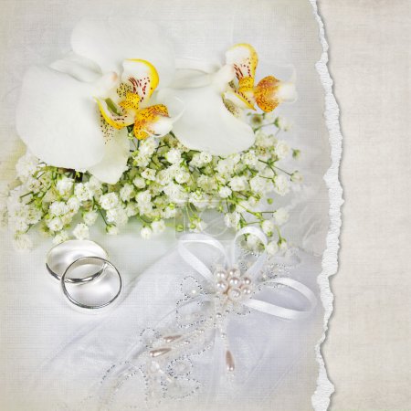 Wedding rings and orchid bouquet
