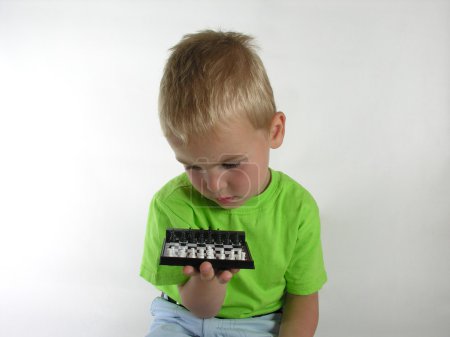 Child thinks on chess