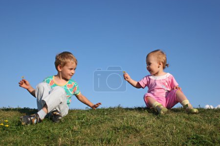 Children on grass with flowers