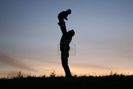 Silhouette father with baby