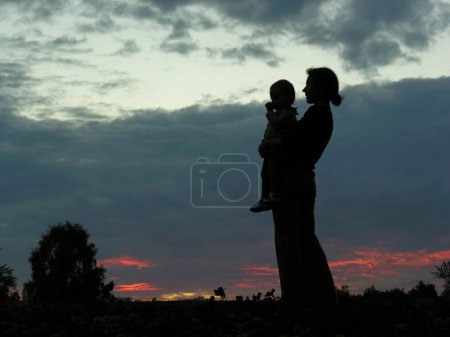Silhouette mother with baby