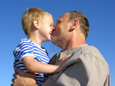 Grandfather with grandson kiss by nose