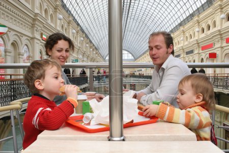 Family in cafe in big shop