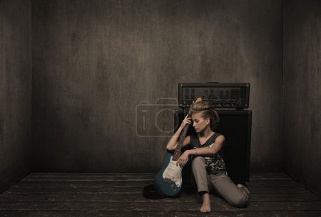 Girl with guitar in a vintage room