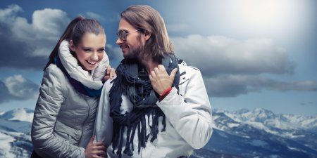 Fashionable couple posing over alpine mountains