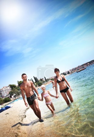 Young family walking on a beach