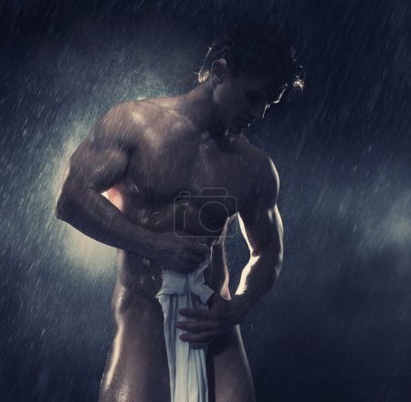 Muscular man having shower