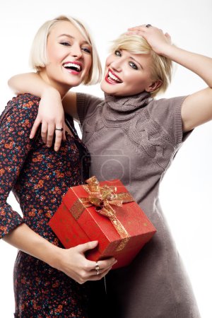 Two blond beauties holding a christmas present