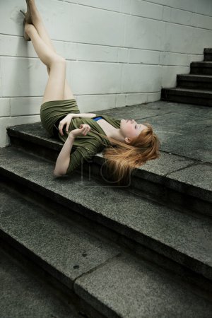 Portrait of young woman lying on ground