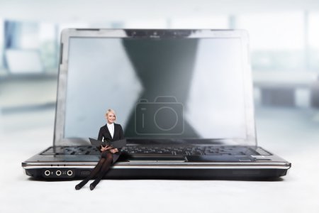 Young businesswoman sitting on a laptop,