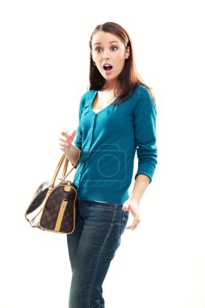 Young shocked brunette shopping isolated on white