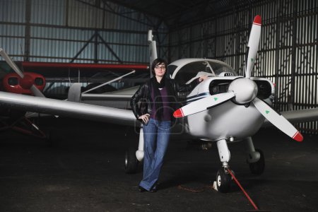 Young woman with private airplane