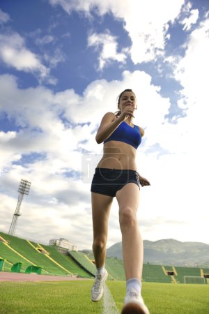 Woman jogging at athletics stadium
