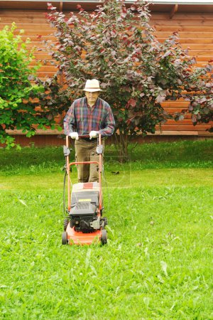 Senior man mowing the lawn