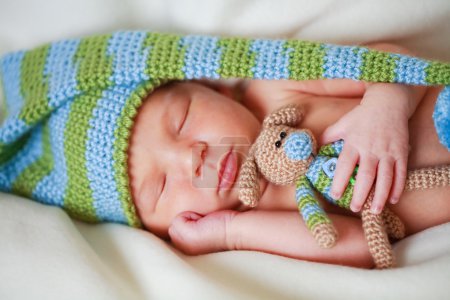Adorable newborn baby with teddy