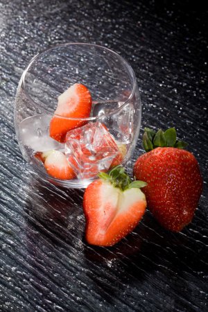 photo of delicious red strawberries on ice cubes