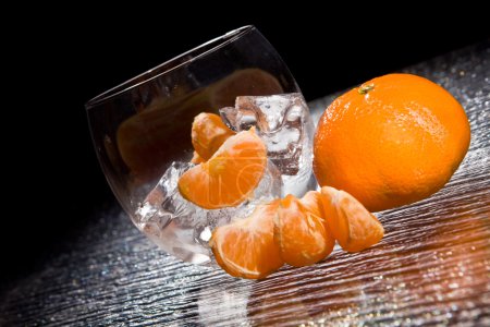 photo of delicious orange mandarins on ice cubes